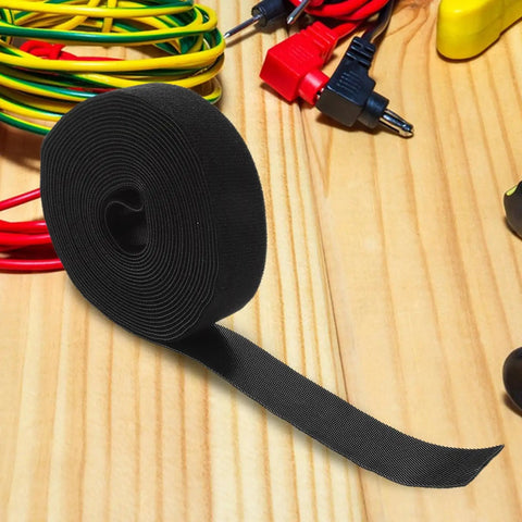 Reusable Black Polyester Cable Ties For Desk Wire Management Heavy Duty Cord Straps For Computer Setup Electronic Organizer on wooden surface.