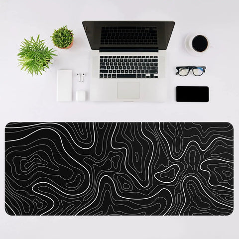 Beastly Ultra Wide Gaming Mouse Pad XL 31.5 By 11.8 Inches With Anti Slip Rubber Base For Keyboard And Mouse Desk Protector Mat In Black With White Topographic Line Perfect For Home Office And Serious Gaming Setups on desk with laptop.