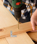 Drilling wood with 100-Piece Stainless Steel L-Shape Corner Bracket Set for 2x2 Inch Small Angle Joints in view