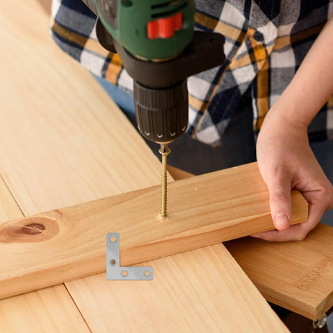 Drilling wood with 100-Piece Stainless Steel L-Shape Corner Bracket Set for 2x2 Inch Small Angle Joints in view