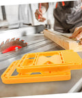Badass Grip Featherboard Safety Clamp For Circular And Band Saws on a table saw with workpiece and blade in view.