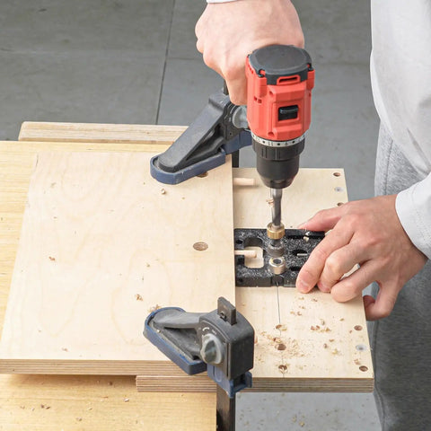 User operating Heavy Duty Woodworking Doweling Jig Kit with Self Centering Anodized Aluminum Body and 6 8 10 mm Drill Bits.