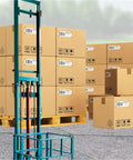 Heavy Duty Electric Scissor Cargo Lift With Wireless Remote Knockout Hydraulic Elevator Platform near stacked boxes on pallets.