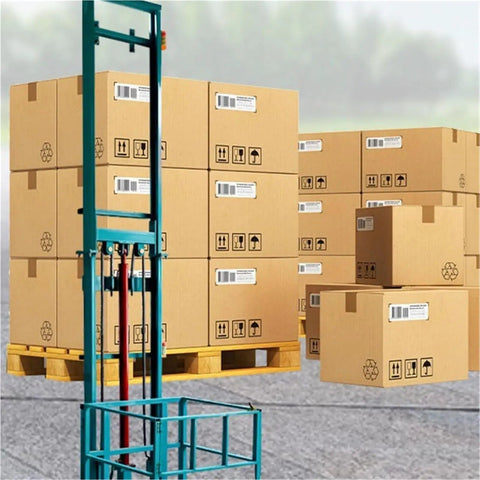 Heavy Duty Electric Scissor Cargo Lift With Wireless Remote Knockout Hydraulic Elevator Platform near stacked boxes on pallets.