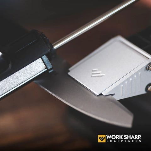 Close-up of Precision Adjustable Knife Sharpener Kit with fixed angle jig sharpening a knife blade at 15 to 30 degrees.