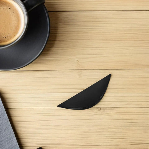 Single black semicircle handle from Six Pack Black Semicircle Push Pull Handles With Self Adhesive Edge Tabs For Cabinets on wooden surface