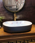 Heavy Duty Premium Top Shelf Oval Ceramic Vessel Bathroom Sink For Countertop Installation With Slick Non Porous Glaze And Smooth Drainage For Restrooms on wooden countertop.