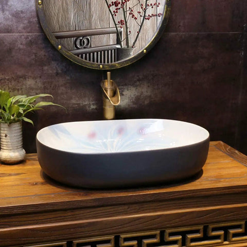 Heavy Duty Premium Top Shelf Oval Ceramic Vessel Bathroom Sink For Countertop Installation With Slick Non Porous Glaze And Smooth Drainage For Restrooms on wooden countertop.