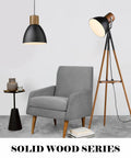 Hammered Pendant Light With Solid Wood And Metal Shade In Black Finish above modern chair in living room setting