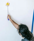 Person using a Slick Paint Roller Brush And Corner Edger For Snug Corners Window Trim And Door Frames Dang Handy Tool.