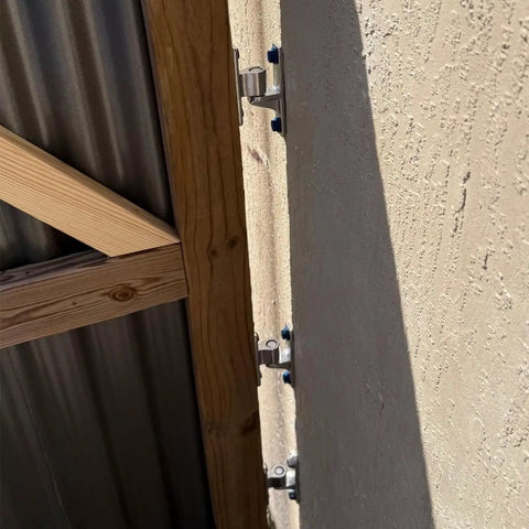 Wall mount gate hinges installed on outdoor chain link fence structure, highlighting the Four Pack Wall Mount Gate Hinges for outdoor use.
