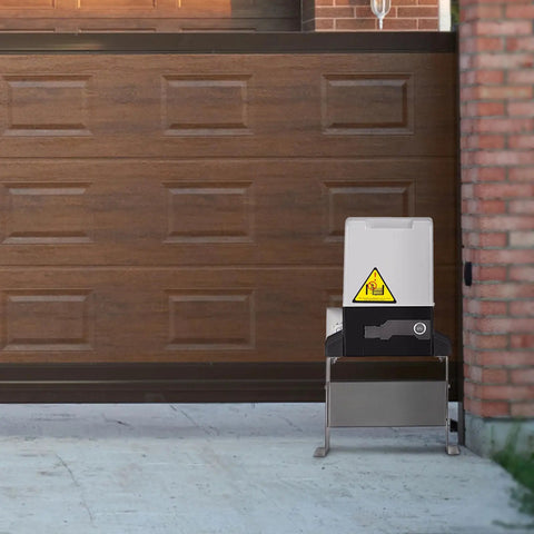 Heavy Duty Automatic Sliding Gate Opener Rigged With Two Remotes And 500W Silent Copper Motor For Driveways Up To 3100 Lbs installed beside a wooden garage door.