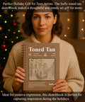 Woman holding Tan Toned Sketchbook For Mixed Media With Sixty Sheets Of 90lb 150gsm Tan Drawing Paper 5.5 By 8.5 Inches