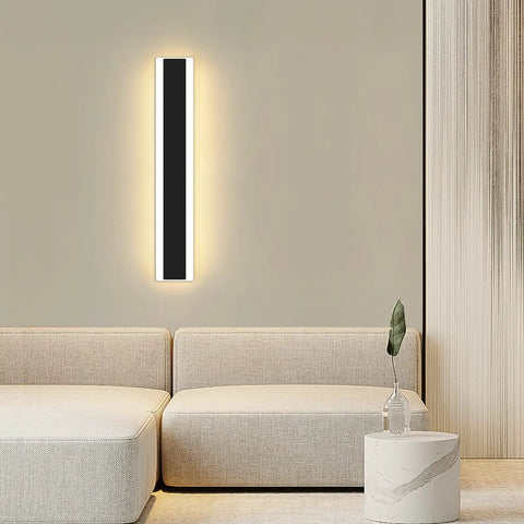 Four Direction Black Acrylic Outdoor Wall Light With 3000K Warm Glow, IP65 Waterproof Exterior Porch Sconce mounted on a wall indoors