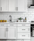 Modern kitchen with white cabinets featuring Black Cabinet Pulls Six And One Quarter Inch Hole Spacing Wide Base Kitchen Cabinet Handles.