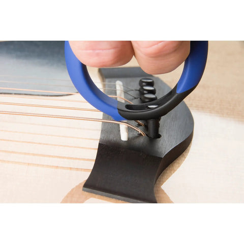 Premium Acoustic Guitar Bridge Pin Puller in use, rubber exterior, one-handed grip, safely lifting bridge pin from guitar.