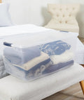 Cleverstore 95 Qt Clear Storage Bin with Lids, 4-Pack showing stacked clothes for home organization in bedroom, made in USA.