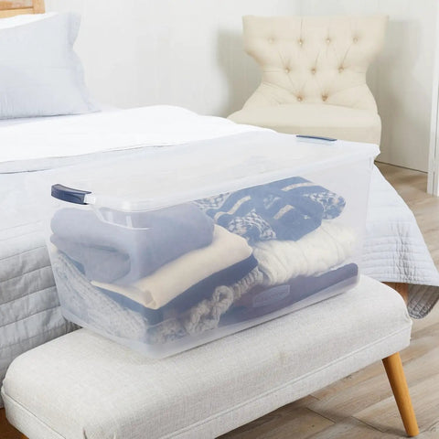 Cleverstore 95 Qt Clear Storage Bin with Lids, 4-Pack showing stacked clothes for home organization in bedroom, made in USA.