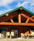 Wooden log cabin exterior showcasing timber beams treated with Stain And Seal In One For Wood Decks And Fences, Natural Cedar, 1 Gallon.