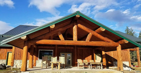 Wooden log cabin exterior showcasing timber beams treated with Stain And Seal In One For Wood Decks And Fences, Natural Cedar, 1 Gallon.