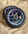 Pro Scooter Replacement Wheels 115x26mm Extra Wide With Hole Design PU 2 Pcs for stunt tricks, showing aluminum core on sand