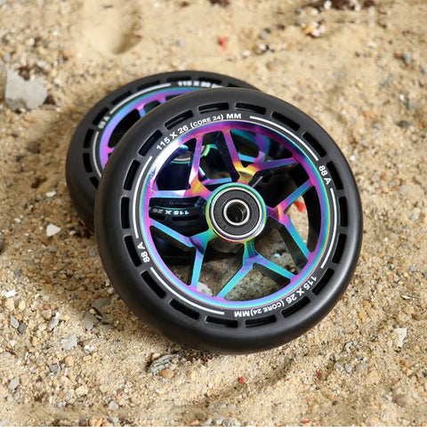 Pro Scooter Replacement Wheels 115x26mm Extra Wide With Hole Design PU 2 Pcs for stunt tricks, showing aluminum core on sand