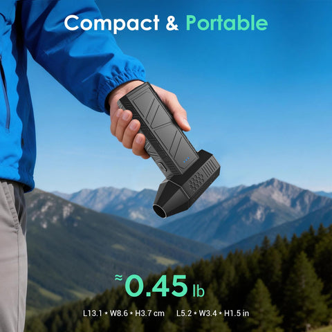 Man holding Cordless Air Duster With 110000 RPM Brushless Motor, Rechargeable 3 Gear Keyboard Cleaner outdoors with mountains in background.