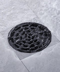 Round Shower Drain Kit Matte Black With Adjustable Base Flange 4 Inch Drain Cover With Threaded Adapter Removable Invisible Look 304 Stainless Steel For Tile Install High Flow 20 To 25 Liters Per Minute in-use with water flow on tile.