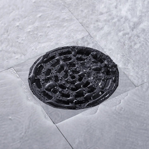Round Shower Drain Kit Matte Black With Adjustable Base Flange 4 Inch Drain Cover With Threaded Adapter Removable Invisible Look 304 Stainless Steel For Tile Install High Flow 20 To 25 Liters Per Minute in-use with water flow on tile.