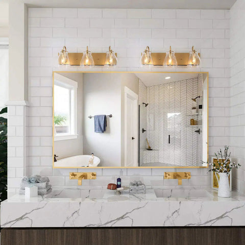 3 Light Modern Vanity Light Fixture in Brass Finish With Clear Glass Shades For Bathroom above a mirror in modern decor