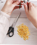Person using tools with 200 Pieces Metal Paper Fasteners Brads Set For Paper Crafts And Scrapbooking Decorative Clips Miniature