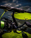 Carbon X Spinning Fishing Reel Ultra Light Carbon Fiber Body And Rotor Six Point Two To One High Speed Gear Ten Plus One Shielded Bearings Smooth Power For Freshwater And Saltwater Fishing 3000 Series shown in water with green line.