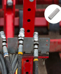 Heavy Duty Steel Shaft Coupling For Auto Lift Motors attached to hydraulic hoses on a red lift, ensuring efficient torque transfer.