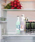 Clear 11 Inch Lazy Susan Organizer With Five Removable Bins in fridge holding bottles and cans, showing versatility and easy access.