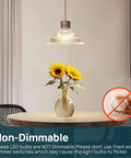 Dining room with pendant lighting using A19 LED Light Bulb 60W Equivalent, 8.5W 4000K Cool White, vase with sunflowers on table.