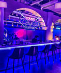 Bar with ambient lighting using Two Pack 100W UV Black Lights For Glow Parties And Stage Lighting IP65 Waterproof Beefy Ultraviolet Lamps