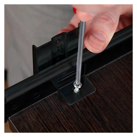 Close-up of heavy duty side mount ball bearing drawer slides pair during installation with a screwdriver on wood.