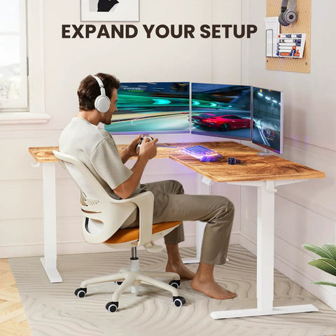 Person gaming at the Ergear 63 Inch L Shaped Electric Standing Desk Adjustable Height Light Vintage Finish.