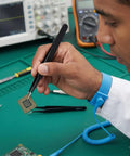 Technician using tweezers from All In One 10 Piece Pro Grade Precision Tweezers Set With Pry Tool, ESD Safe Stainless Steel Kit for electronics repair.