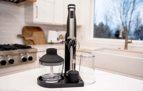 Professional Grade Commercial Blending Machine With A Badass 1800 Watt Motor And Dead Simple Variable Speed Settings For Top Shelf Bar Mixes And Cafe Kitchens In Rust Proof Stainless Steel, with attachments on countertop.
