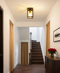 Flush Mount Ceiling Light Fixture With Clear Glass Shade In A Farmhouse Black Metal Frame installed in a modern hallway.