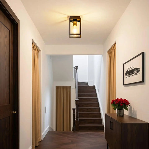 Flush Mount Ceiling Light Fixture With Clear Glass Shade In A Farmhouse Black Metal Frame installed in a modern hallway.