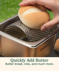 Hand using Stainless Steel Butter Wheel For Griddles And Grills Raised Bottom Butter Roller For Even Spreading On buns