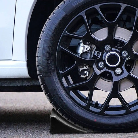 2 Pack Solid Rubber Wheel Chocks For Cars, Trucks, RVs, ATVs And Travel Trailers under a car wheel, durable rubber for stability
