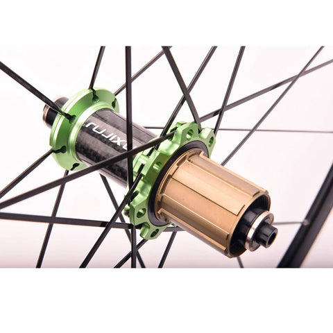 Close-up of carbon fiber tube hub on a 700C road bike wheelset with 30mm deep rim for street speed, sealed bearings seen