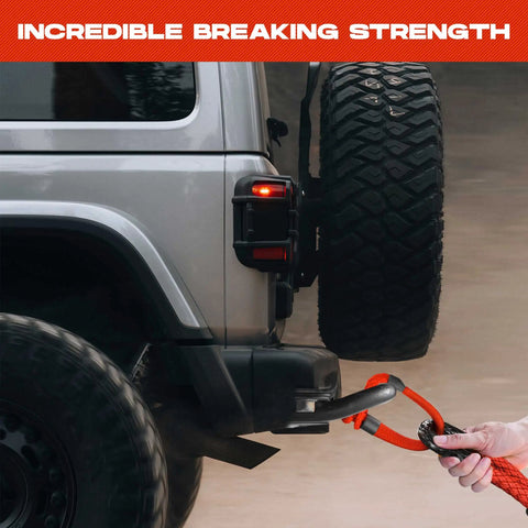 Spectra Fiber Soft Shackle Recovery 7/16 By 6 Inch demonstrating towing on SUV with braided sleeve and storage bag.