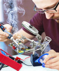 Person using All In One Soldering Kit With 80W Adjustable Temperature Iron, Multimeter, Helping Hand for circuit board repair.