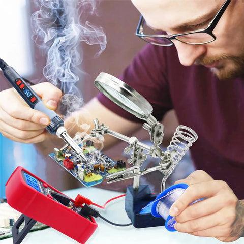 Person using All In One Soldering Kit With 80W Adjustable Temperature Iron, Multimeter, Helping Hand for circuit board repair.