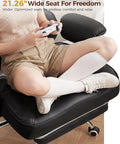 Person sitting on Big And Tall Office Chair For Heavy Duty Comfort With Deluxe Embossed Leather High Back Ergonomic Computer Chair With Foot Rest, showcasing wide seat