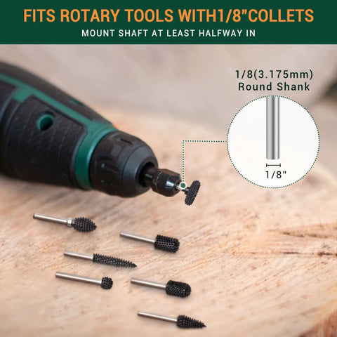 Side view of 1/8-inch shank carbide rotary burrs for wood carving; one burr in a green drill, several burrs on wood.